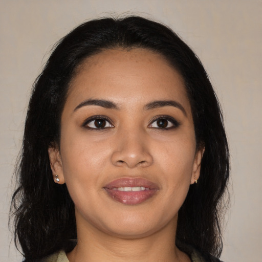 Joyful latino young-adult female with long  black hair and brown eyes