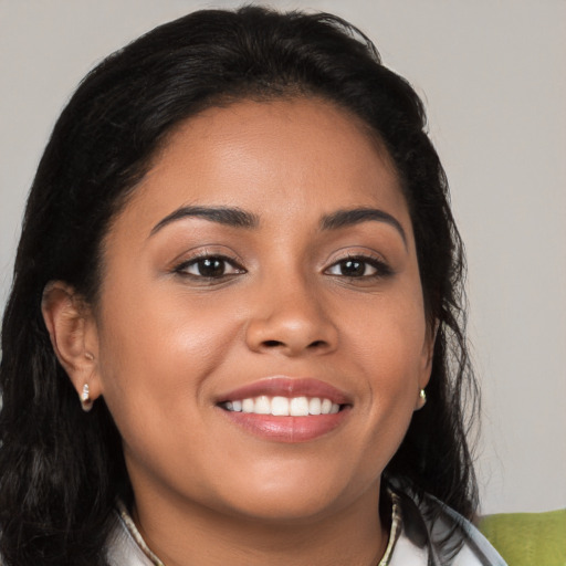 Joyful latino young-adult female with medium  brown hair and brown eyes