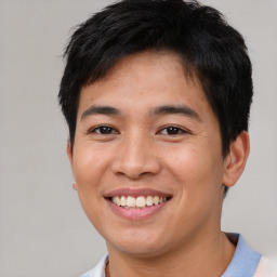 Joyful asian young-adult male with short  brown hair and brown eyes