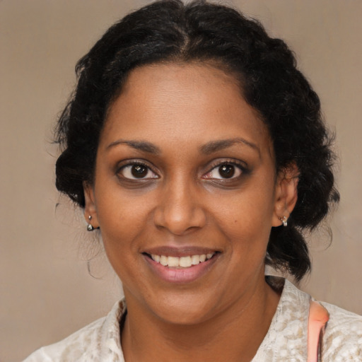 Joyful black young-adult female with medium  brown hair and brown eyes