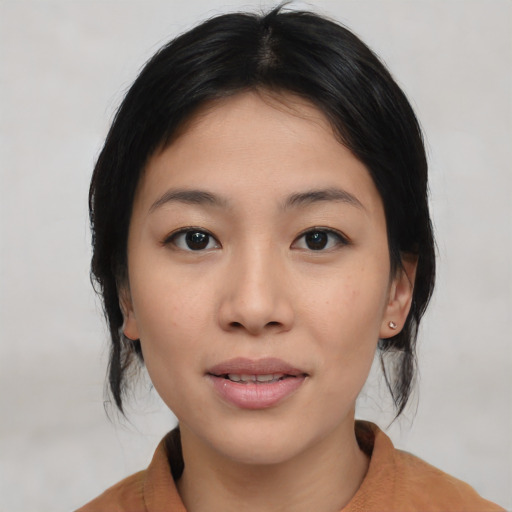 Joyful asian young-adult female with medium  black hair and brown eyes
