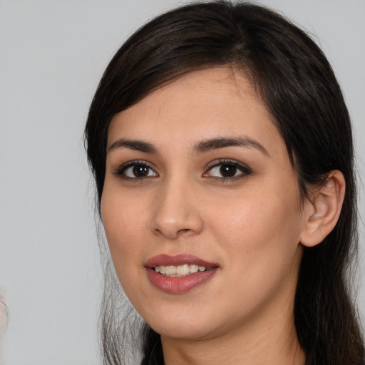 Joyful white young-adult female with long  black hair and brown eyes