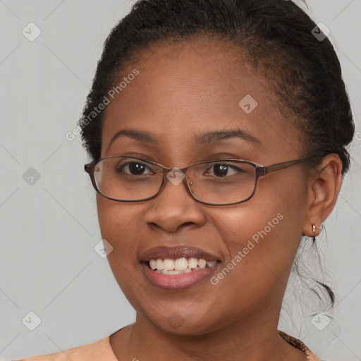 Joyful black young-adult female with short  brown hair and brown eyes