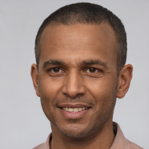 Joyful latino adult male with short  brown hair and brown eyes