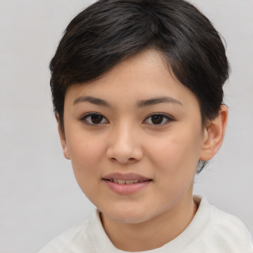 Joyful asian child female with medium  brown hair and brown eyes