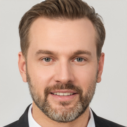 Joyful white adult male with short  brown hair and brown eyes