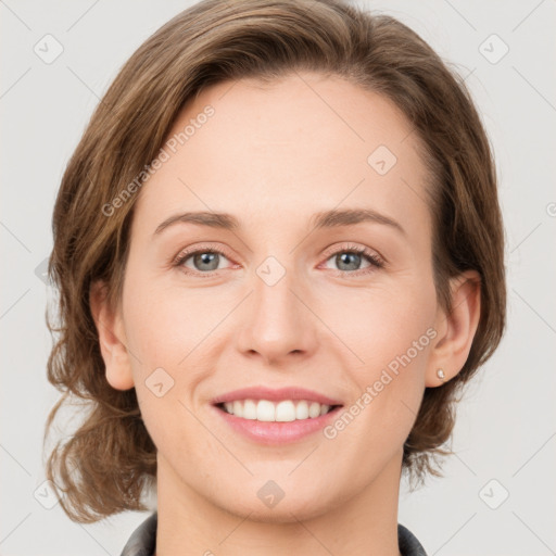 Joyful white young-adult female with medium  brown hair and green eyes