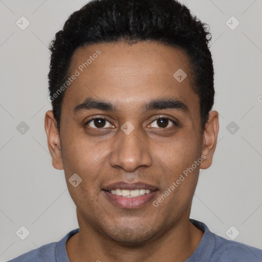 Joyful black young-adult male with short  black hair and brown eyes