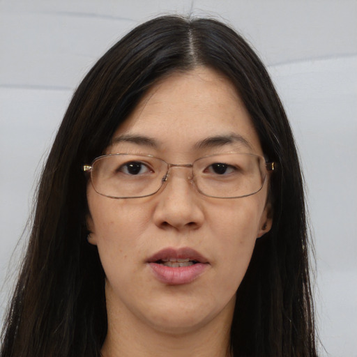 Neutral asian adult female with long  brown hair and brown eyes