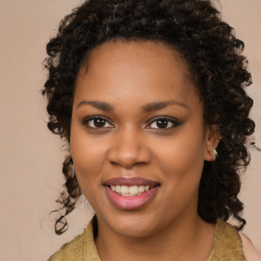 Joyful black young-adult female with medium  brown hair and brown eyes