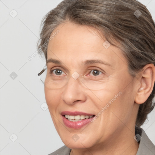 Joyful white adult female with medium  brown hair and grey eyes