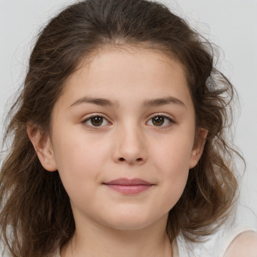 Joyful white child female with medium  brown hair and brown eyes