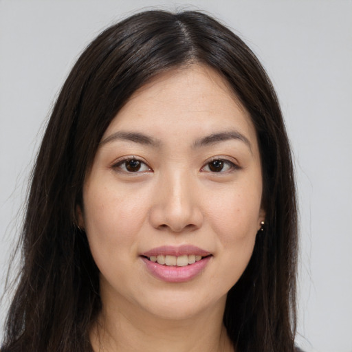 Joyful asian young-adult female with long  brown hair and brown eyes
