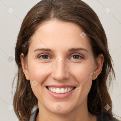 Joyful white young-adult female with medium  brown hair and grey eyes