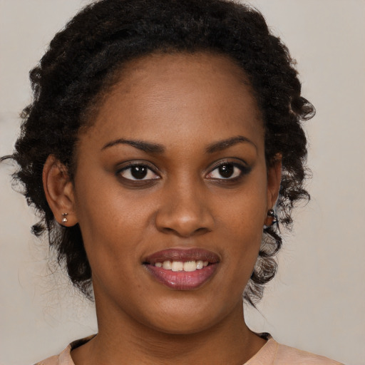 Joyful black young-adult female with medium  brown hair and brown eyes