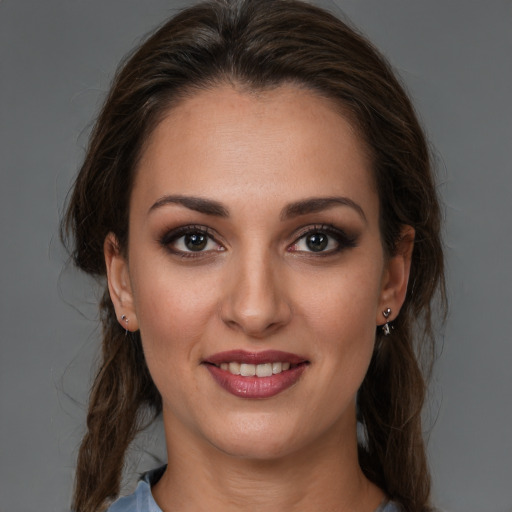 Joyful white young-adult female with medium  brown hair and brown eyes