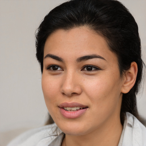Joyful latino young-adult female with medium  brown hair and brown eyes