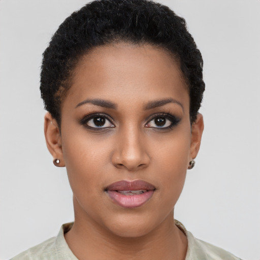 Joyful black young-adult female with short  brown hair and brown eyes