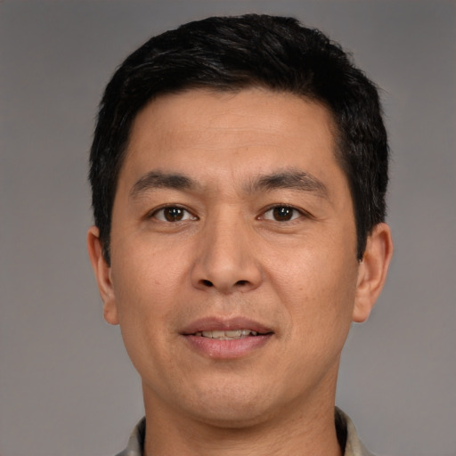 Joyful white young-adult male with short  black hair and brown eyes