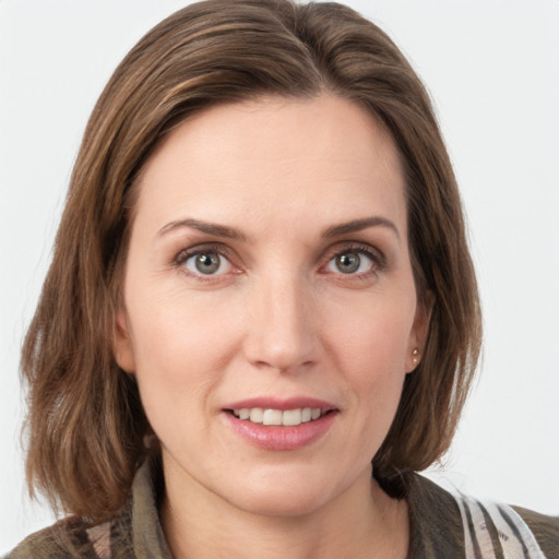 Joyful white young-adult female with medium  brown hair and grey eyes