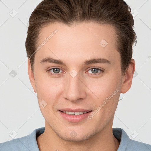 Joyful white young-adult male with short  brown hair and grey eyes