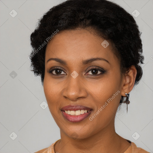 Joyful black young-adult female with short  black hair and brown eyes