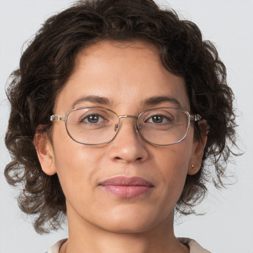 Joyful white adult female with medium  brown hair and grey eyes