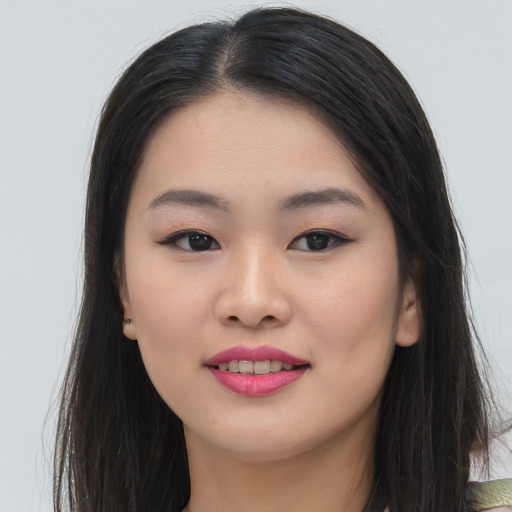 Joyful asian young-adult female with long  brown hair and brown eyes