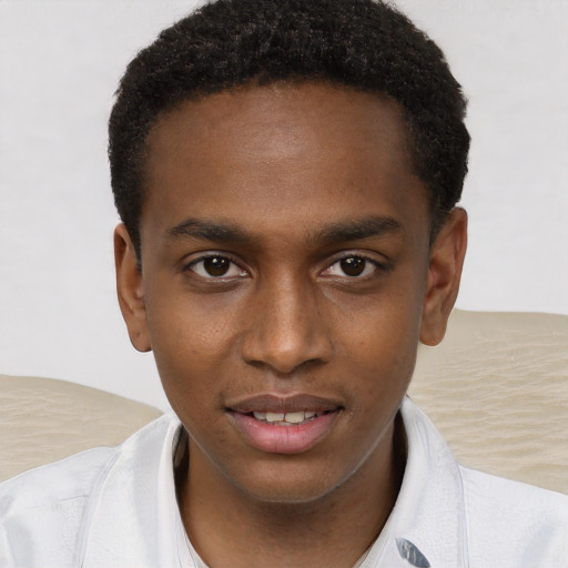 Joyful black young-adult male with short  brown hair and brown eyes