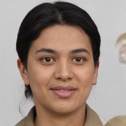 Joyful asian young-adult female with medium  brown hair and brown eyes