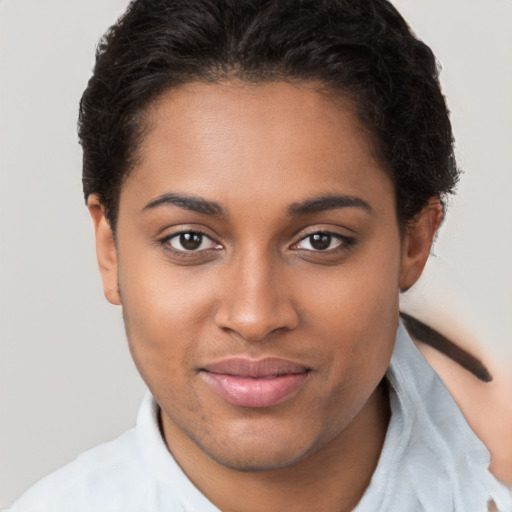 Joyful latino young-adult female with short  brown hair and brown eyes