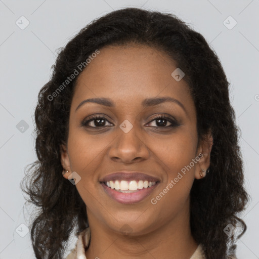 Joyful black young-adult female with long  brown hair and brown eyes