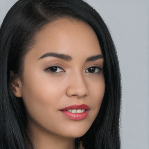 Joyful asian young-adult female with long  brown hair and brown eyes