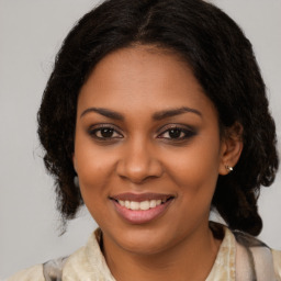 Joyful black young-adult female with medium  brown hair and brown eyes