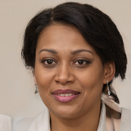 Joyful black adult female with medium  brown hair and brown eyes