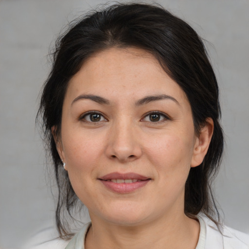 Joyful white adult female with medium  brown hair and brown eyes