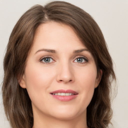 Joyful white young-adult female with medium  brown hair and green eyes