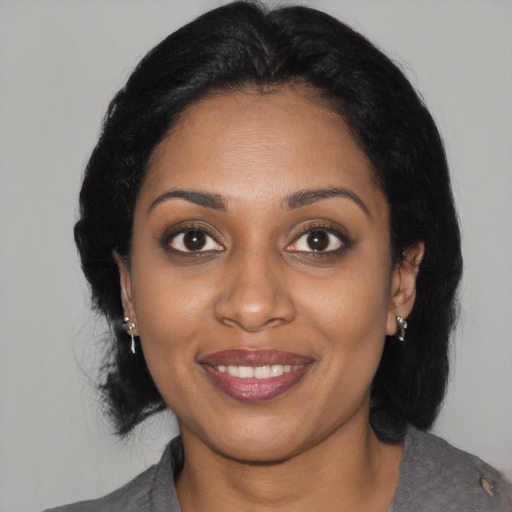 Joyful black young-adult female with medium  black hair and brown eyes