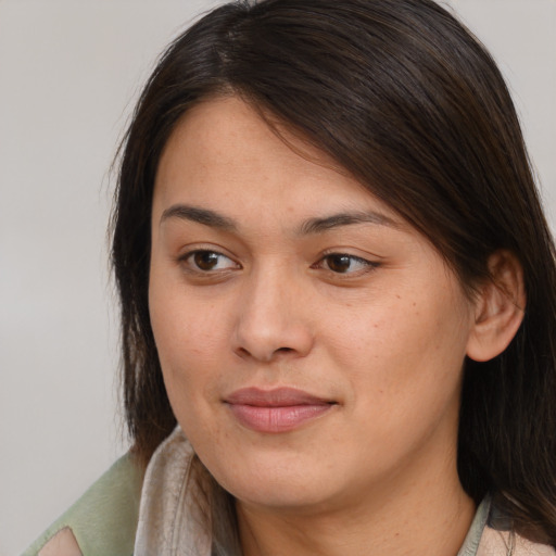 Joyful latino young-adult female with medium  brown hair and brown eyes