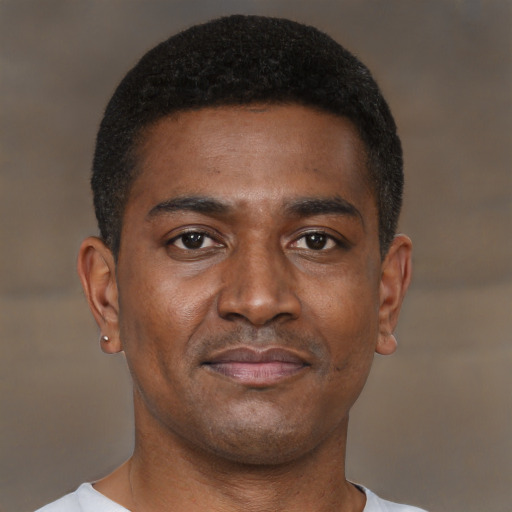 Joyful black young-adult male with short  brown hair and brown eyes