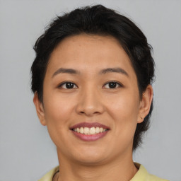 Joyful asian young-adult female with short  brown hair and brown eyes