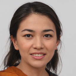 Joyful asian young-adult female with medium  brown hair and brown eyes