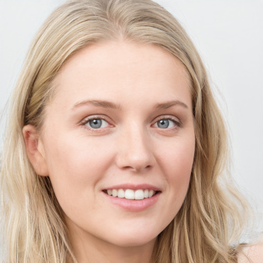 Joyful white young-adult female with long  brown hair and blue eyes