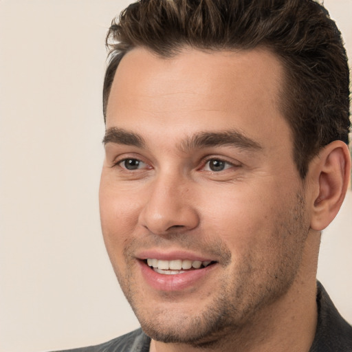 Joyful white young-adult male with short  brown hair and brown eyes