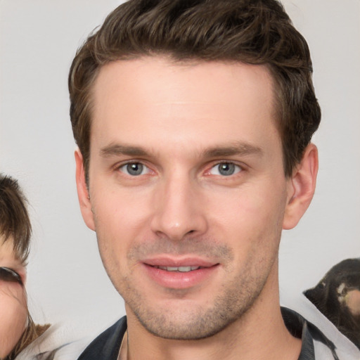 Joyful white young-adult male with short  brown hair and brown eyes