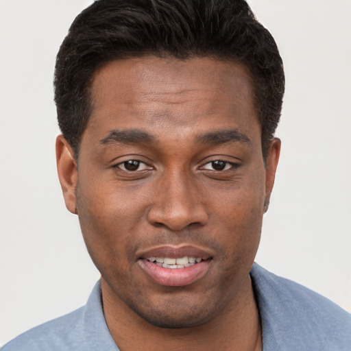 Joyful black young-adult male with short  brown hair and brown eyes