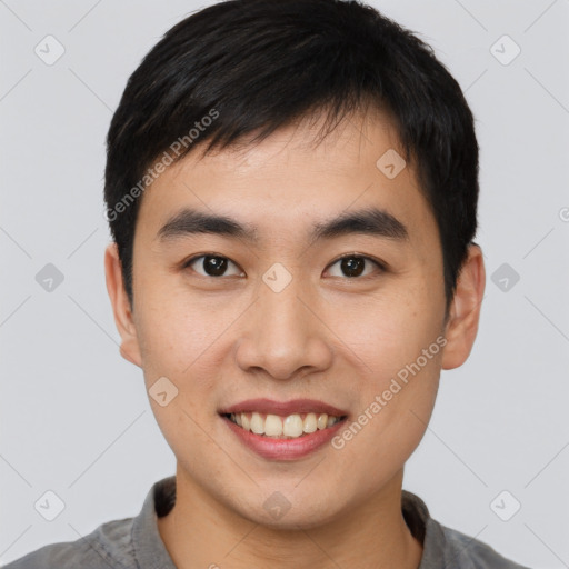 Joyful asian young-adult male with short  brown hair and brown eyes