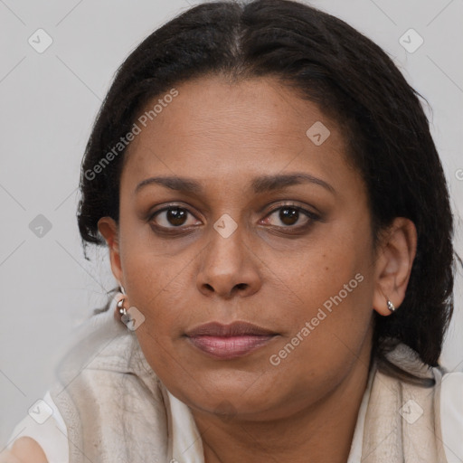 Joyful black young-adult female with long  brown hair and brown eyes