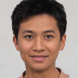 Joyful asian young-adult male with short  black hair and brown eyes