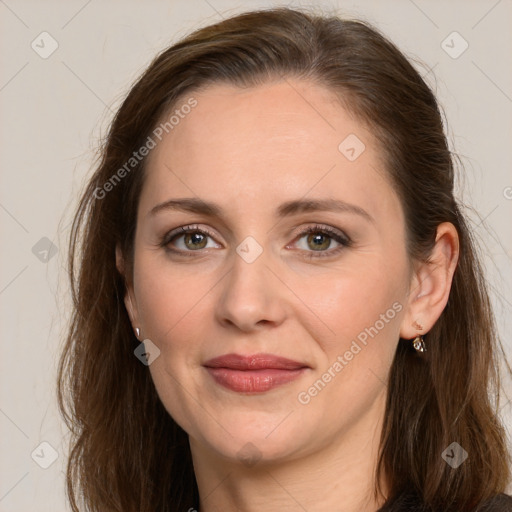 Joyful white adult female with long  brown hair and grey eyes